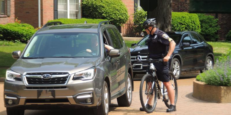 officer talking to person in a car