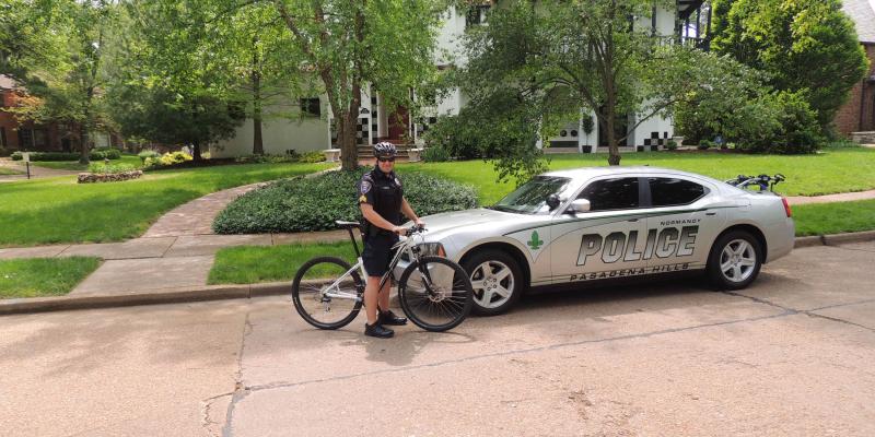 officer on bike next to police car