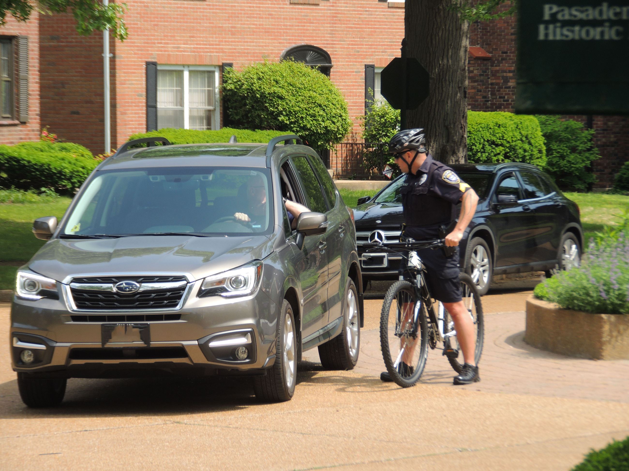 officer talking to person in a car